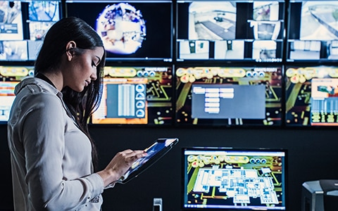 Woman in Security Monitor Room